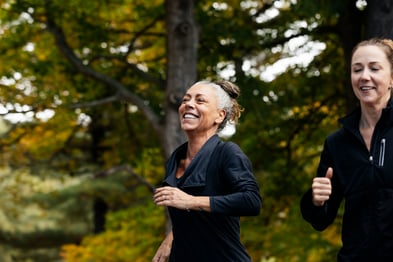 A middle-aged woman jogs with a female companion